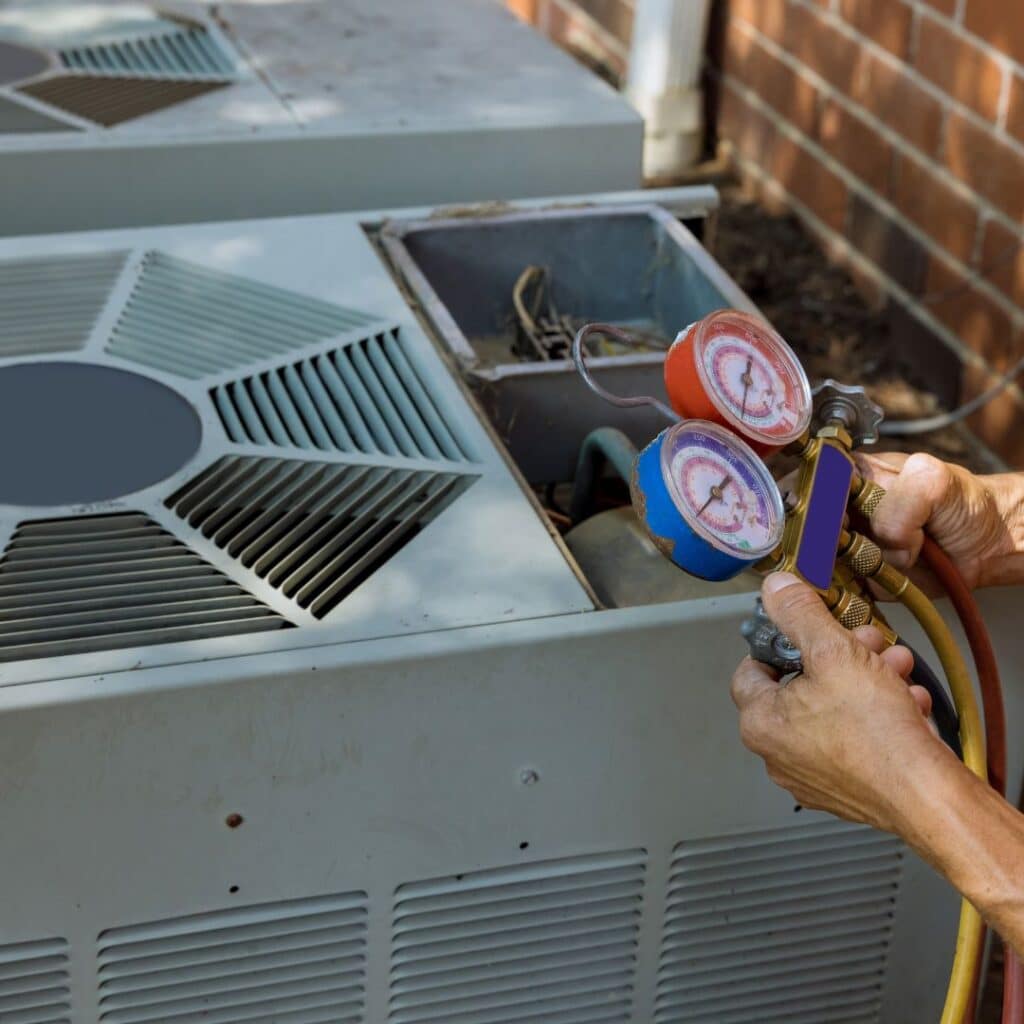 heating and air conditioning contractor working on an hvac unit that needs maintenance 