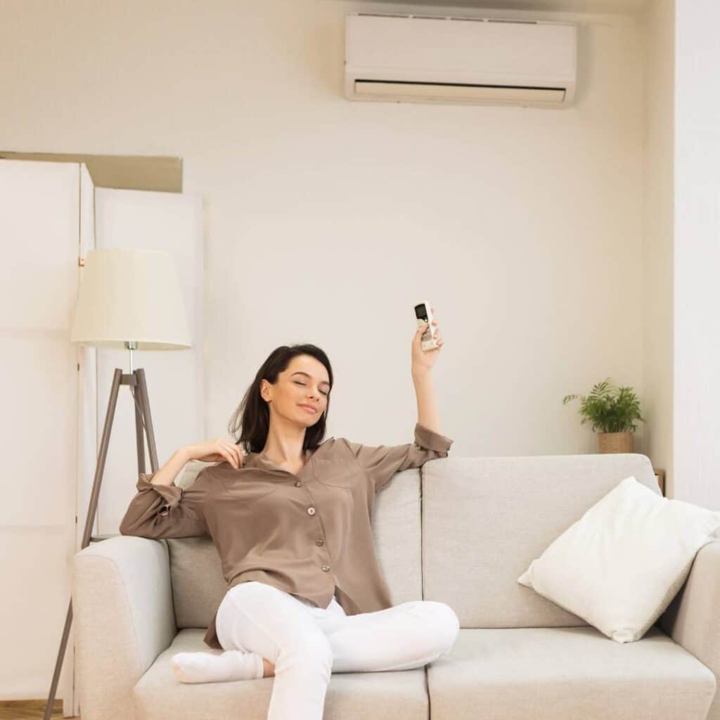 woman inside her home enjoying her newly installed HVAC system