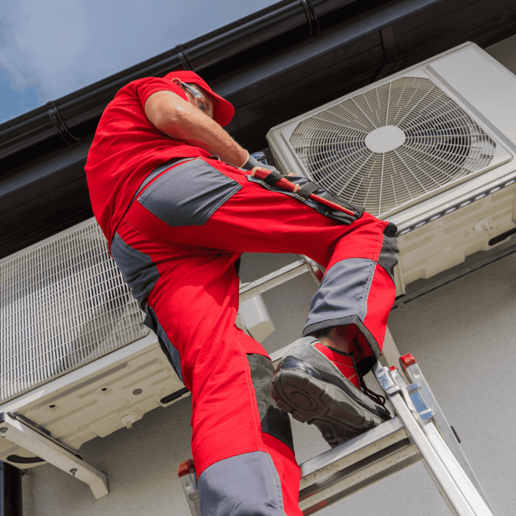 hvac professional fixing a water leak on an hvac system
